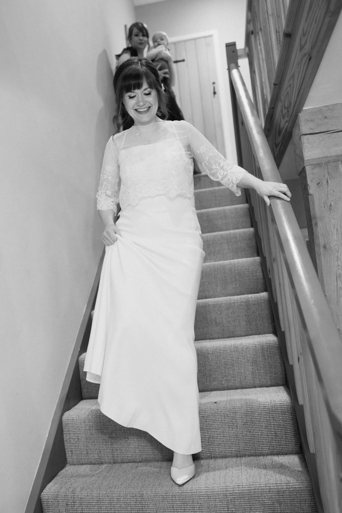 Black and white glamorous bride walking down stairs